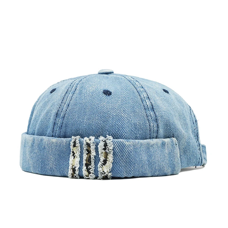 Light blue denim cap with distressed details on a white background