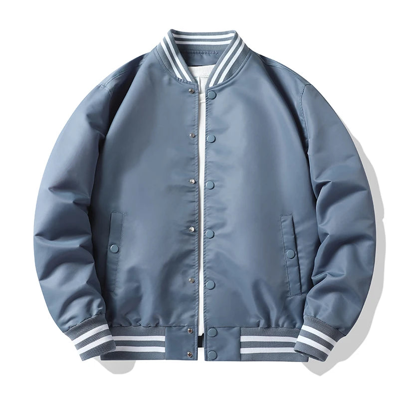 Blue bomber jacket with white and gray striped cuffs and collar on a white background