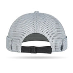 Model wearing mesh brimless docker cap — side on-head view