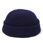 Navy blue knit beanie on a white background