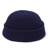 Navy blue knit beanie on a white background
