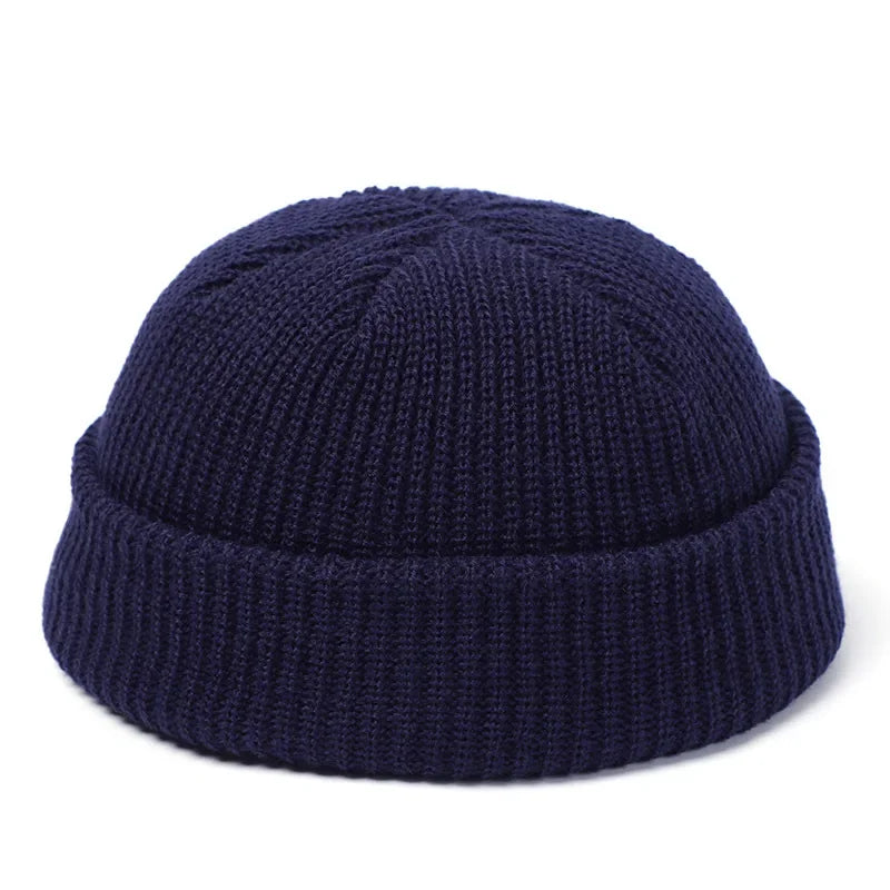 Navy blue knit beanie on a white background