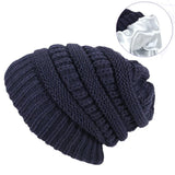Navy blue knitted beanie with close-up inset on a white background
