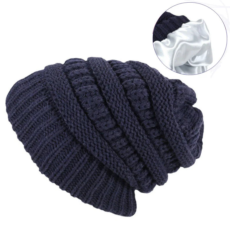 Navy blue knitted beanie with close-up inset on a white background