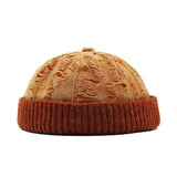 orange beanie with textured top and ribbed band on a white background
