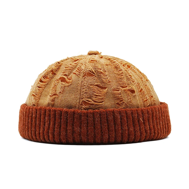 orange beanie with textured top and ribbed band on a white background