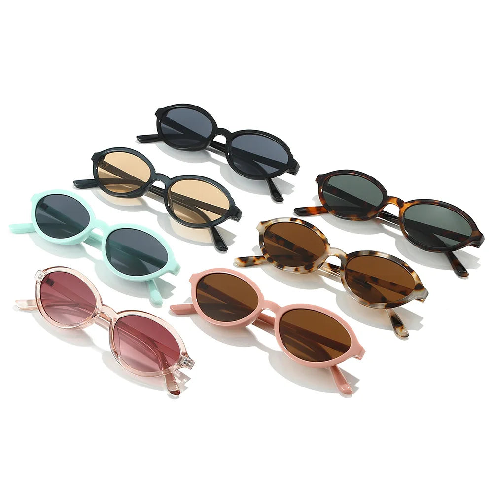 Model wearing small oval gradient sunglasses front-on — retro 90s small frame style