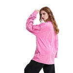 Person wearing a pink long-sleeve shirt on a white background