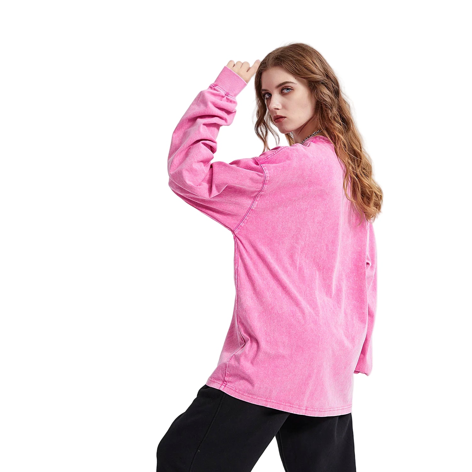 Person wearing a pink long-sleeve shirt on a white background