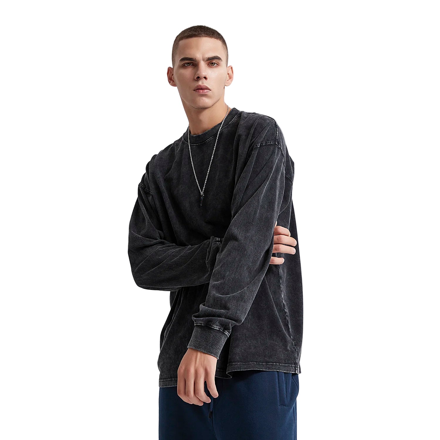 Man wearing a black long-sleeve shirt against a white background