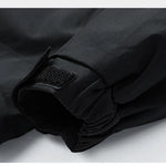 Close-up of a black jacket with a patch on a light gray background