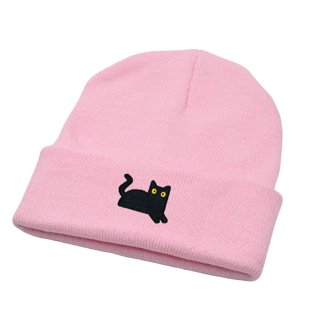 Pink beanie with a black cat design on a white background