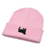 Pink beanie with a black cat design on a white background