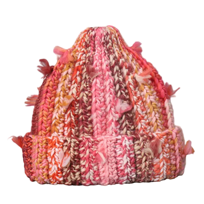 Multicolored knitted hat with tassels on a gray background