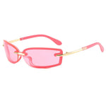 Pink sunglasses with gold accents on a white background