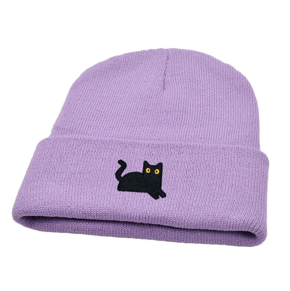 Purple beanie with a black cat embroidered on a white background