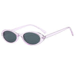 Purple-Black Model wearing small oval cat eye sunglasses outdoors in natural light