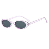 Purple-Black Model wearing small oval cat eye sunglasses outdoors in natural light