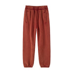 Red Sweatpants flat lay showing elastic waistband, zip pockets and tapered ankle cuffs