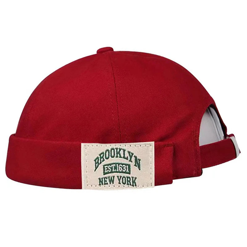 Red cap with a 'Brooklyn New York' label on a white background