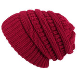Red knitted beanie on a white background