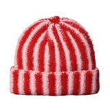 Red and white striped knit beanie on a gray background