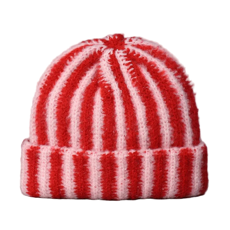 Red and white striped knit beanie on a gray background