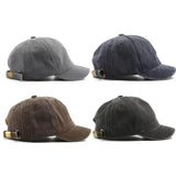Four different gray baseball caps on a white background
