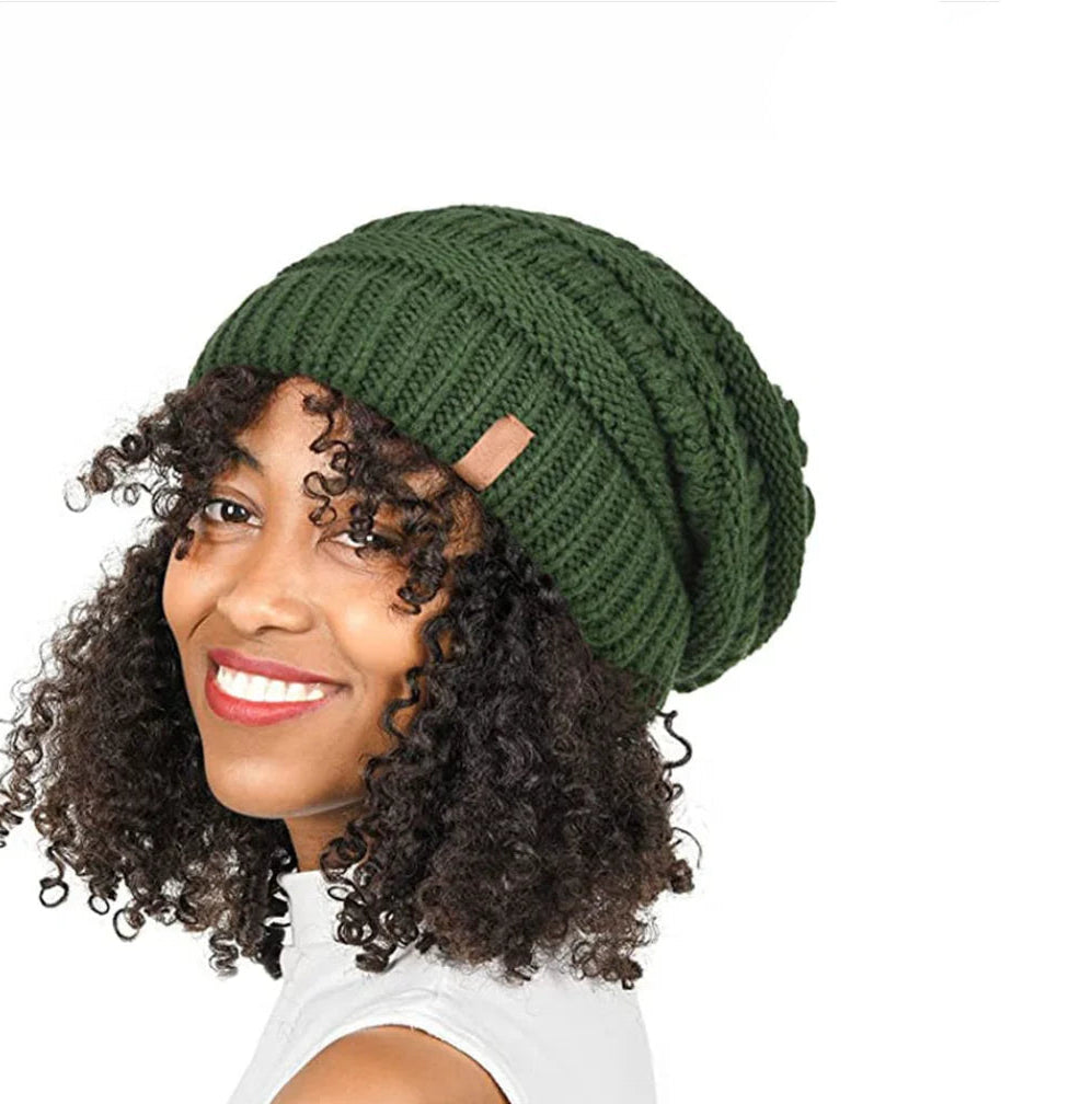 Woman wearing a green knitted beanie on a white background