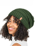 Woman wearing a green knitted beanie on a white background