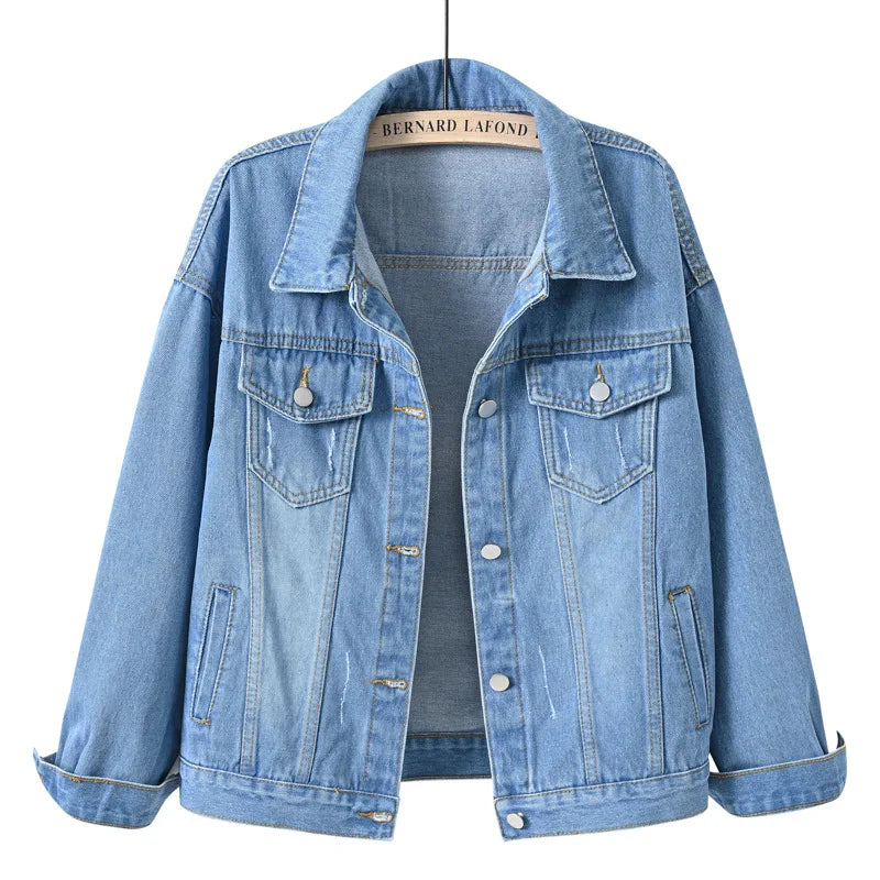 Shallow  Blue Close-up fabric detail of women's oversized denim jacket showing cotton denim texture