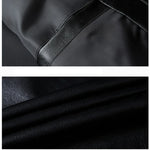 Close-up of black leather texture with a focus on stitching detail.