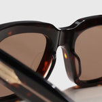 Square acetate sunglasses, close-up detail of frame and lens