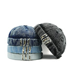 Stack of denim-style beanies on a white background