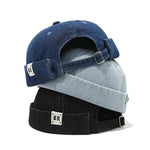 Three denim caps stacked on top of each other with visible brand logo.