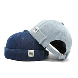 Two denim baseball caps, one blue and one gray, on a white background.
