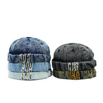 Two denim hats stacked on a white background