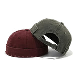 Two baseball caps, one red and one gray, on a white background