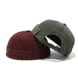 Two baseball caps, one red and one gray, on a white background