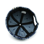 Blue denim cap with black interior and stitching on a white background