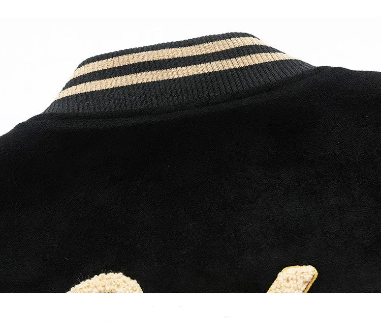 Close-up of a black garment with gold trim on a white background