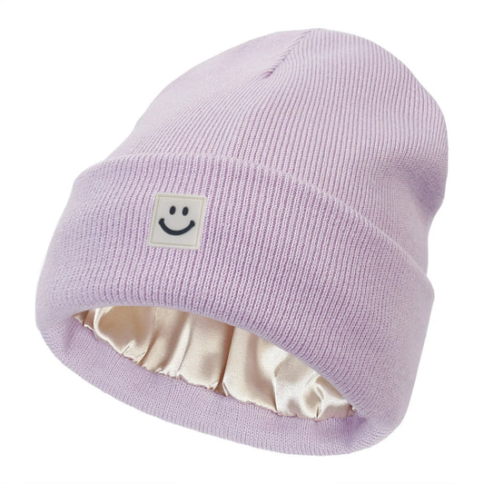 Violet knit beanie with a smiley face patch on a white background