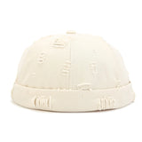 White Model wearing cotton docker cap, three-quarter view