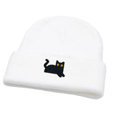 White beanie with a black cat design on a white background
