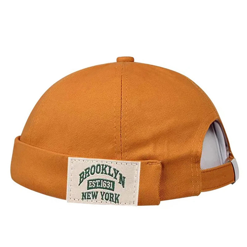 Yellow cap with a 'Brooklyn New York' label on a white background