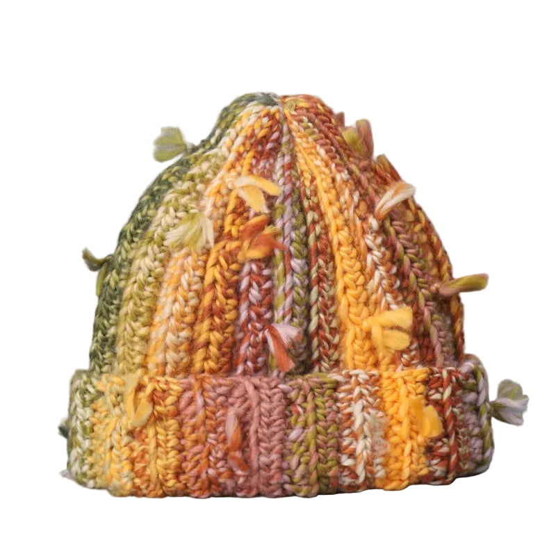 Knitted hat with autumnal colors on a gray background