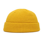 Yellow knit beanie on a white background