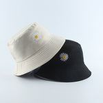 Beige And Black Bucket hat shown stacked in beige and black colorways with daisy embroidery