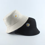 Beige And Black Bucket hat shown stacked in beige and black colorways with daisy embroidery