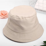Beige Kids bucket hat angled view showing stitched brim and crown